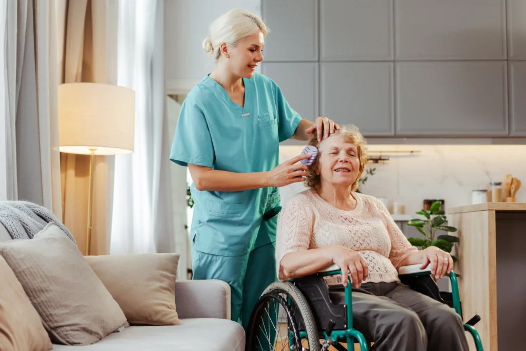 Caregiver grooming relaxed elderly woman wheelchair.