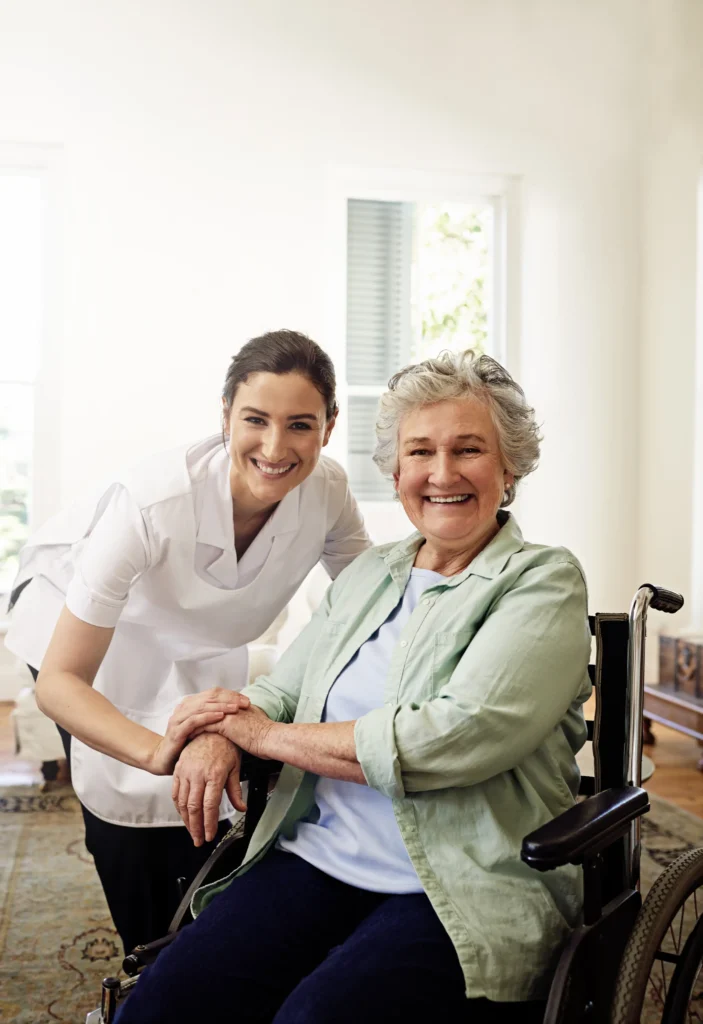 Caregiver smiling with elderly woman wheelchair.