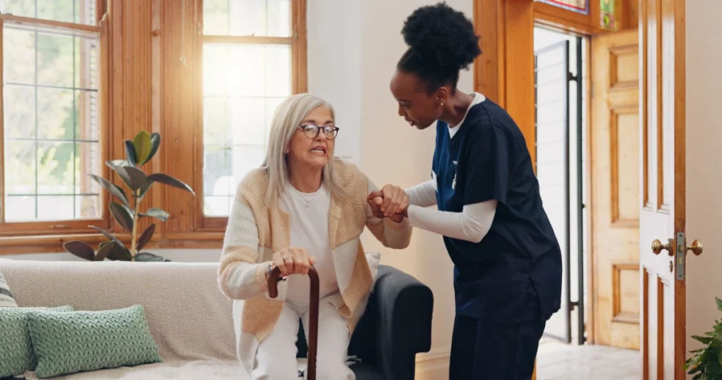 Caregiver supporting senior woman outdoors near Savage Maryland