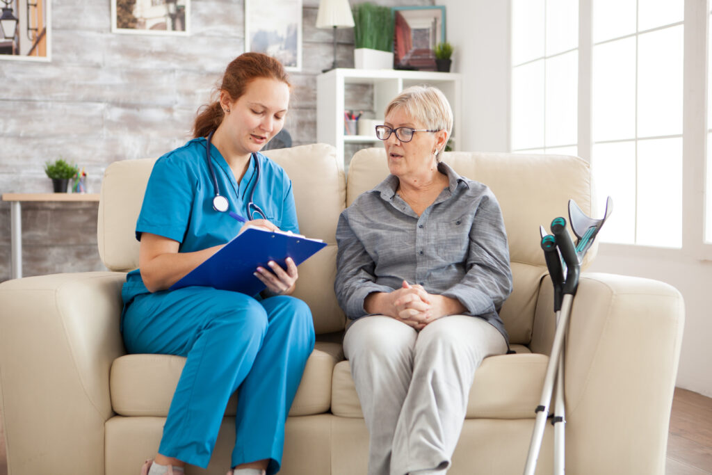 Female doctor in nursing home doing survey on senior