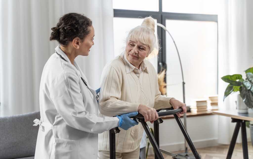 Doctor assisting elderly woman walking.
