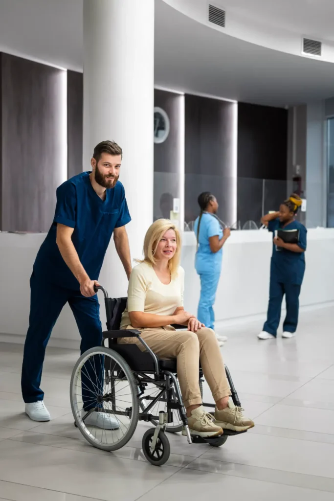 Healthcare worker pushing smiling woman wheelchair.