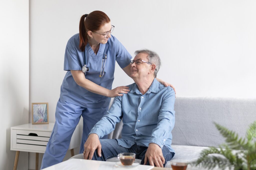 Nurse is smiling towards her patient.